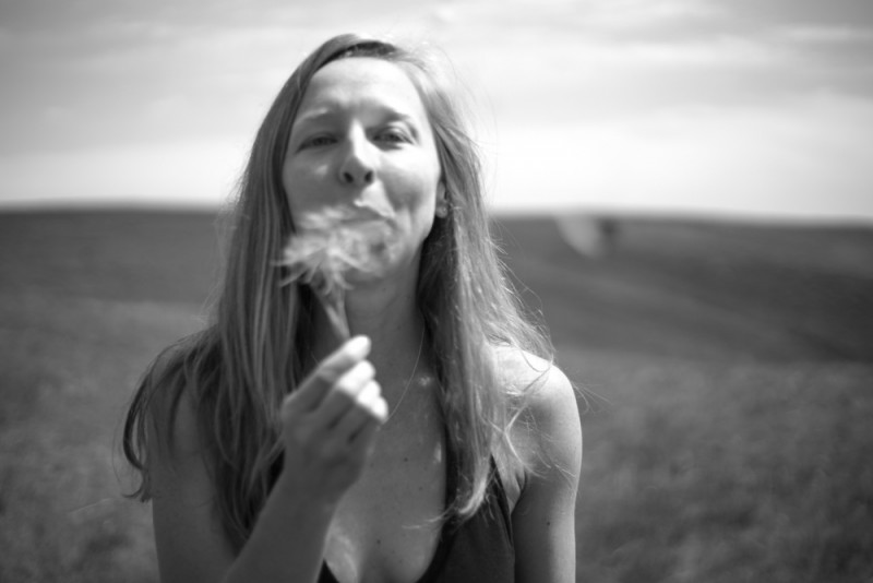 girl blowing dandelion