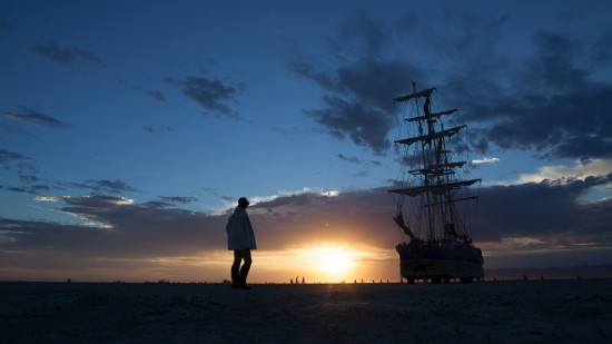Woman and ship silhouette at sunrise at Burning Man 2012 on northtosouth.us