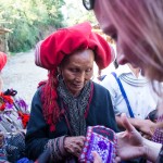 Red Dao women selling embroidered pouches and purses in Sapa, Vietnam