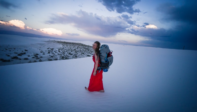 Backpacking in a red dress at White Sands National Monument