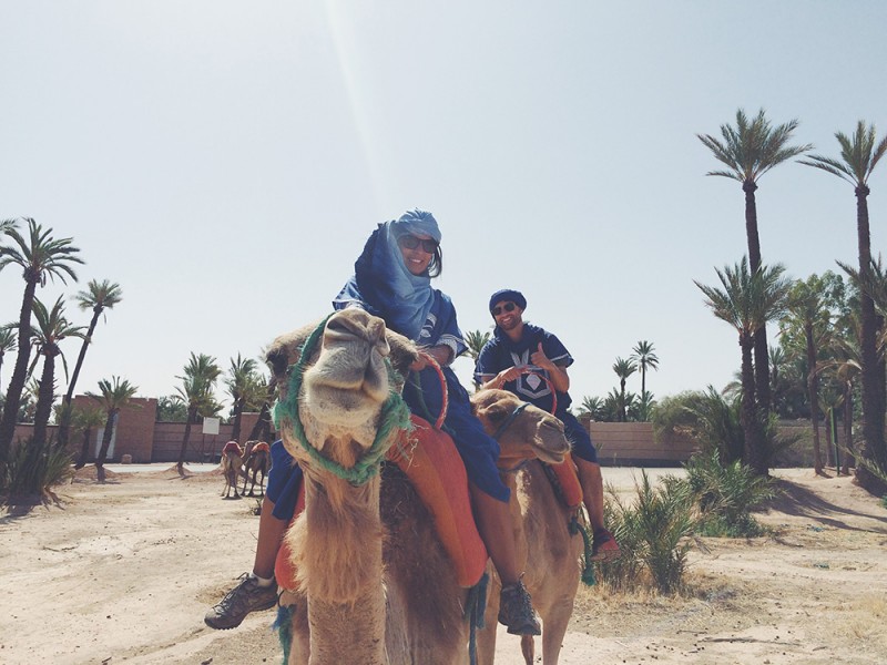 Chris Tyre and Ismary Torres riding camels in Morocco