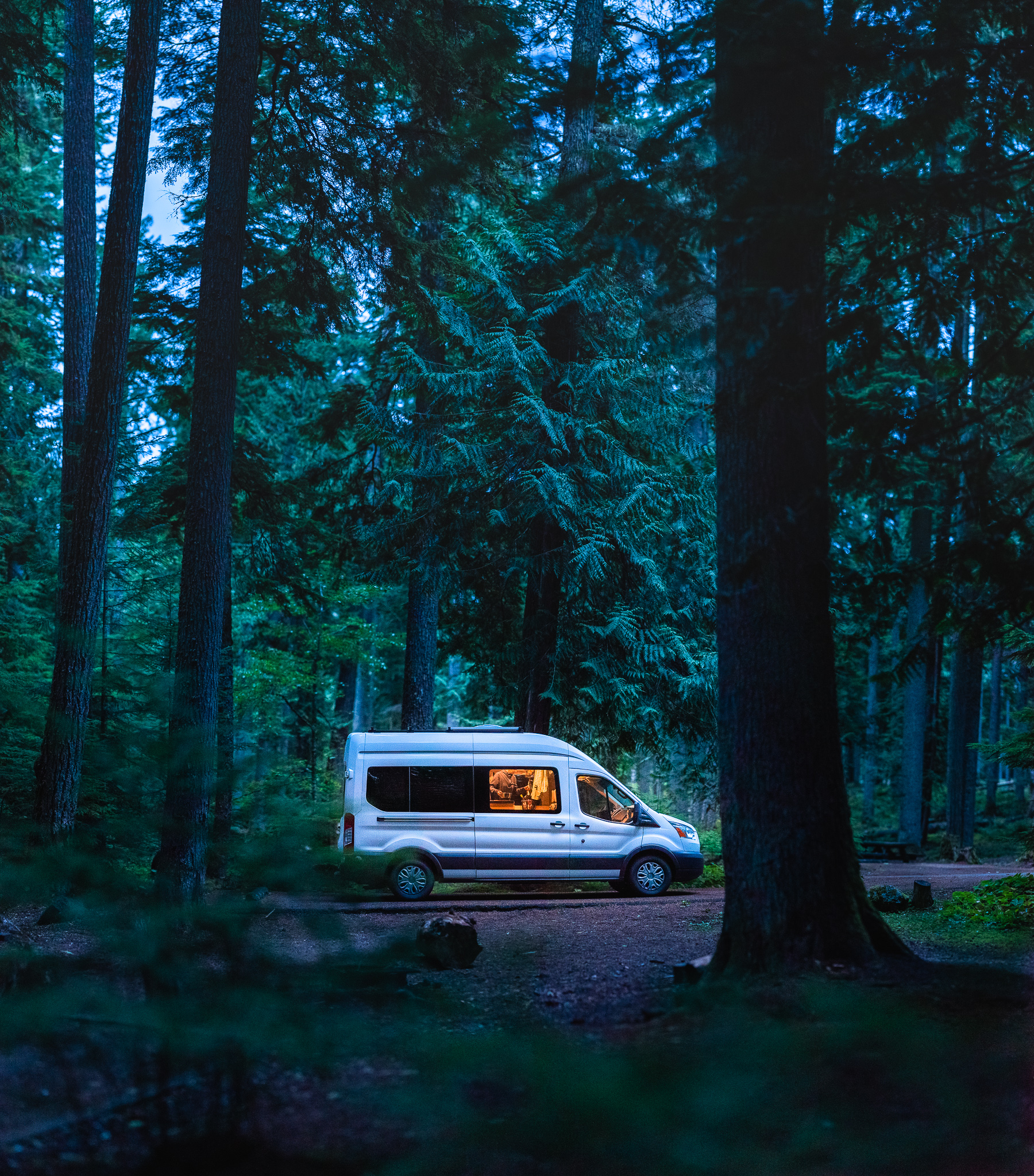 Cozy Ford Transit Campervan in the forest at Silver Springs Campground, Washington